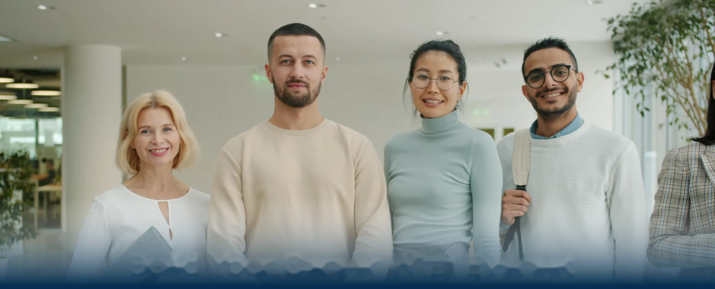 Four Everest Fleet colleagues standing together in the office